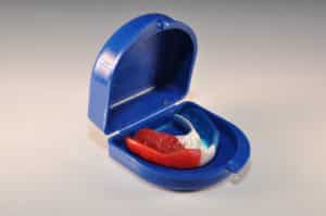 A custom-made sports mouthguard - mouthguard sitting in mouthguard case